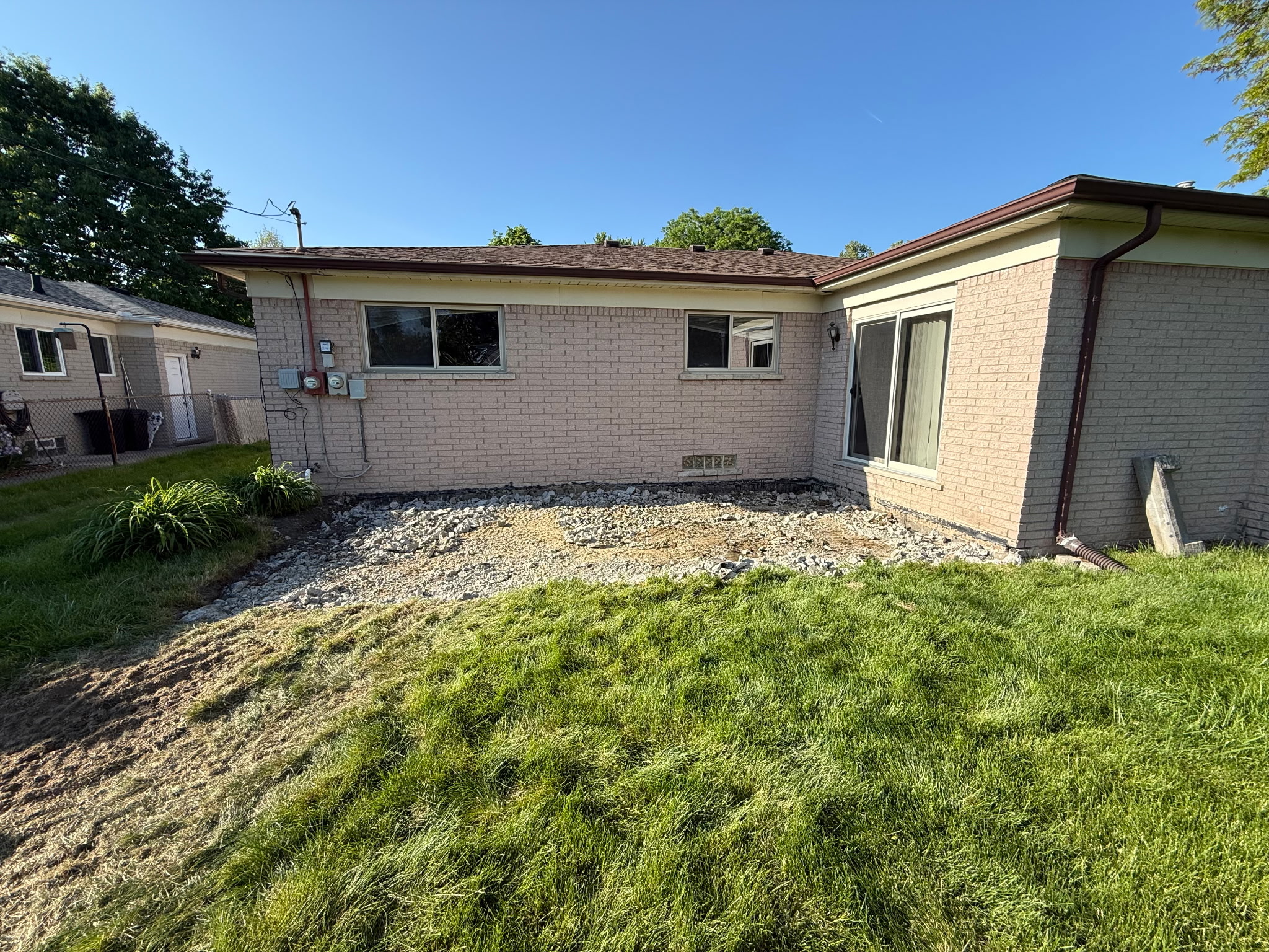 Cleared backyard after concrete patio removal in Southeast Michigan