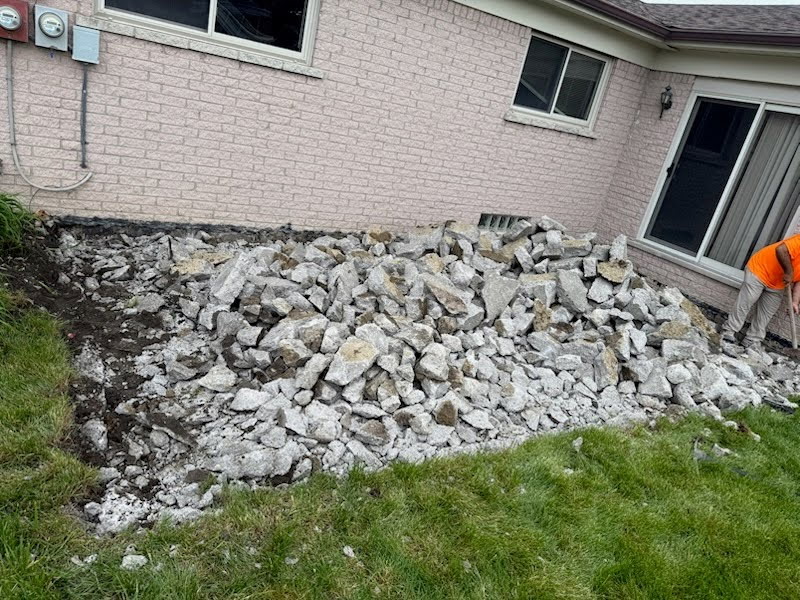 Backyard with broken concrete patio before removal
